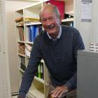 South Otago High School 100th Jubilee convener John Fenby looks through historic photos in the...