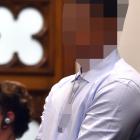 The defendant stands in the dock on the first day of the trial. Photo: Peter McIntosh