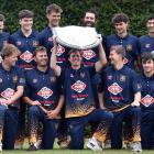 Taieri captain Beckham Wheeler-Greenall hoists the Bing Harris Shield as he and his team-mates...