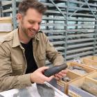 Southern Pacific Archaeological Research senior archaeologist Dr Chris Jennings holds a stone...