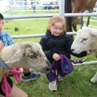 Flannery siblings Thomas, with winning lamb Blackie, and second-place ribbon holder Annabel, with...