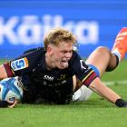 Finn Hurley celebrates after scoring a try during the Super Rugby Pacific match between the...