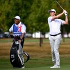 Daniel Hillier plays a shot at the New Zealand Open at Millbrook as caddy Steve Williams keeps a...