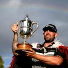 Australian Ryan Peake celebrates with the winner’s trophy after his victory in the New Zealand...