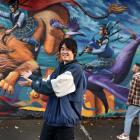 South Dunedin Street Trail artist Koryu Aoshima in front of the extension to his Cameron St mural...