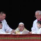 Pope Francis speaks from a balcony, on the day the "Urbi et Orbi" (to the city and to the world)...