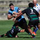 Wakatipu Prems halfback James Valentine looks to break the shackles during his side’s convincing...