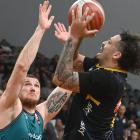 Otago Nuggets small forward Jose Perez gets a shot off despite the attention of Auckland forward...