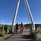 Dutch Dunedin resident Jessica de Heij leads a group of cyclists wearing orange along the Otago...