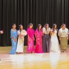 Clutha District Cultural Feast announcer Kirstin Chittock (left) presents local Filipino women...