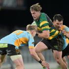 Green Island wing Michael Manson is sandwiched by University defenders Finlay Hagen (left) and...