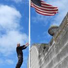 Oamaru Whitestone Civic Trust co-chairman Graeme Clark hoists the American flag for the East of...
