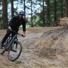 Christening the fresh trail with his bike is Waikaia Trails Trust member Sam Ruddenklau. PHOTO:...