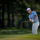 Justin Rose chips on to the 17th green in the first round of the Masters at Augusta today. Photo:...