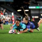 Matatū winger Winnie Palamo is tackled by Blues opposite Jaymie Kolose while scoring a try during...