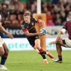 Damian McKenzie of the Chiefs makes a break during tonight's Super Rugby Pacific match against...