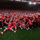 Liverpool players celebrating after being named champions of the Premier League at Anfield after...