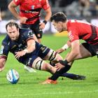 Highlanders forward Oliver Haig pounces on the ball in front of Crusaders fullback Will Jordan...