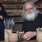 Ma Fi Arts teacher Matthew Robertson shapes a bit of clay while partner Fiona Robertson holds a...