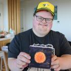Oamaru artist Todd Rawson at home with one of his artworks featuring in the North Otago IHC...