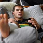 Green Island rugby player Ronan Dynes has his feet up as he recovers at home with a broken leg....