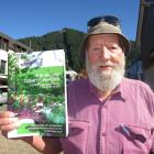 Jim Childerstone with his book decrying wilding pine ‘fundamentalists’. PHOTO: ARCHIVE