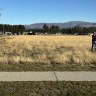 Lisa Riley and her son on the site of the proposed Super Liquor store.  Photo: Supplied/Lisa Riley