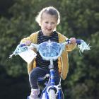 Nora Gorton tries out a bike she got from the Southern Youth Development bike grab yesterday....