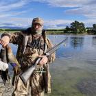 Oamaru duck-shooter Matthew Williams holds a mallard duck and paradise duck harvested from All...