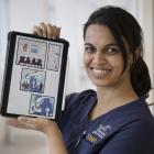 Dentistry PhD student Vaishnavi Yeleswarapu with one of the comics she has created to promote...