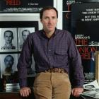 American writer Joseph Wambaugh, January 1980. Behind him is a poster for his work The Onion...