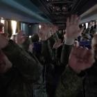 A screen capture from a video shows 307 Russian servicemen in captivity being returned while 307...