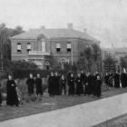 Priests and students gather outside Holy Cross College, a Catholic theological seminary in...