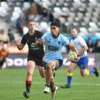 King’s High School flanker Jeremiah Tuhega-Vaitupu runs away from Waitaki Boys’ High School...
