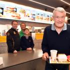 Ray Stonelake sen is served the first meal at the new Green Island McDonald’s by his son Justin,...