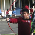 John Sausa, 11, aims his bow with the help of Ken Hedges. PHOTOS: NIC DUFF