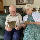 Noel Dickel and Faye Ormandy look at the photo of the 1921 relay team which included Mr Dickel’s...