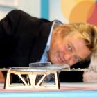 Professor David Hutchinson demonstrates a high-temperature superconducting ceramic tablet...