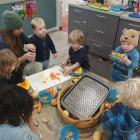 Teacher Jessie Reynolds helps Arrowtown Preschool tamariki prepare vege soup for Monday’s...