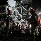 Rescue and security personnel work at an impact site following missile attack from Iran on Israel...