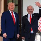 President Donald Trump speaks as Israeli Prime Minister Benjamin Netanyahu waves following a...
