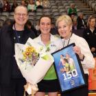 Kristie Simpson (centre) celebrates her 150th game with long-serving umpire support Kirsten Lloyd...