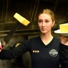 Speight’s Ale House Dunedin staff member Bella Mangos holds up a sliced pound of butter. PHOTO:...