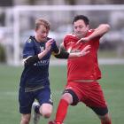 Otago University’s Blake Allison (left) battles for the ball with Northern Hearts’ Bradley...