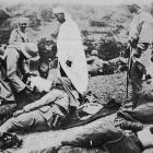 A French doctor tends wounded Algerians at a dressing station at Tanouat during the war in...