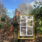 Nikki Broad holds a placard she has made protesting the lack of greenery in Gore aviary. PHOTOS:...