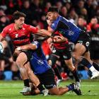 The Crusaders' Noah Hotham fends off Rieko Ioane of the Blues during the match. Photo: Getty