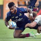 Highlanders midfielder Timoci Tavatavanawai is tackled by Blues flanker Dalton Papali’i during...