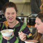 Tia Taita (left) and her friend Shannon van Rooijen enjoy a meal at the North East Valley Project...