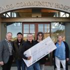 Presenting a cheque for the Otago Hospice from the Oxo Cubans are (from left) band manager Mark...